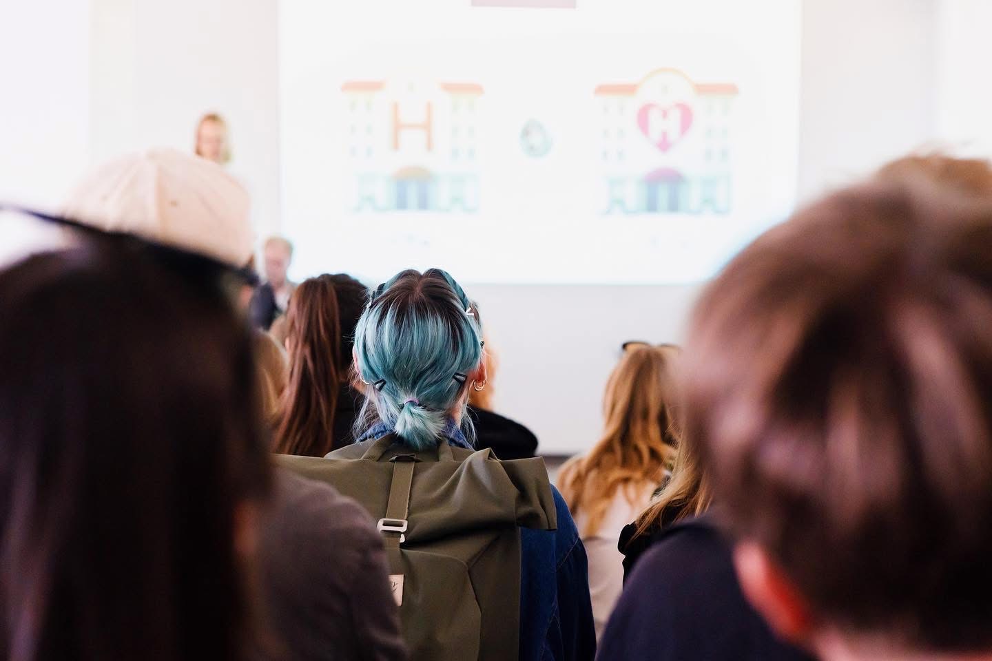 The audience watching the projected emoji score over the performers' heads